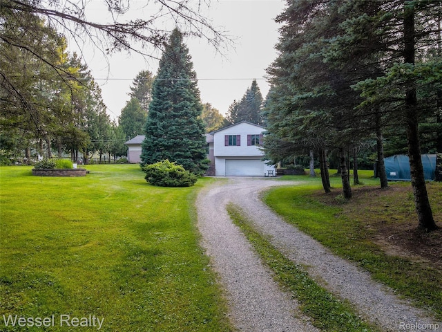 2465 Texter Rd, Leonard, MI 48367 - view of front facade featuring driveway, a front lawn, and an attached garage