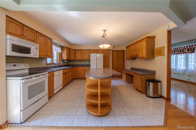 2465 Texter Rd, Leonard, MI 48367 - kitchen with white appliances, open shelves, dark countertops, a center island, and brown cabinets