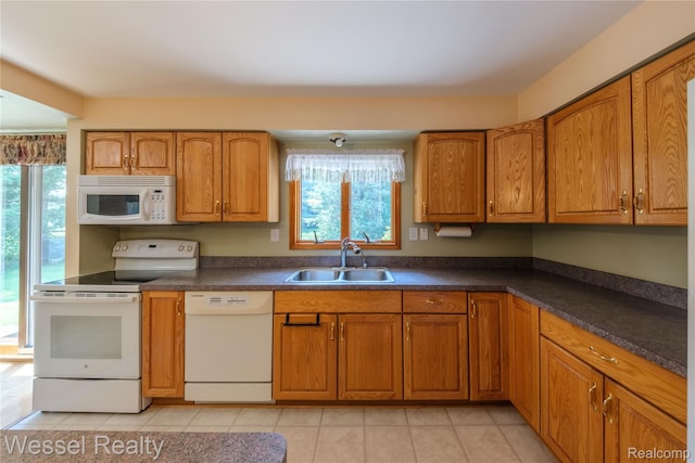 2465 Texter Rd, Leonard, MI 48367 - kitchen featuring white appliances, plenty of natural light, and brown cabinetry