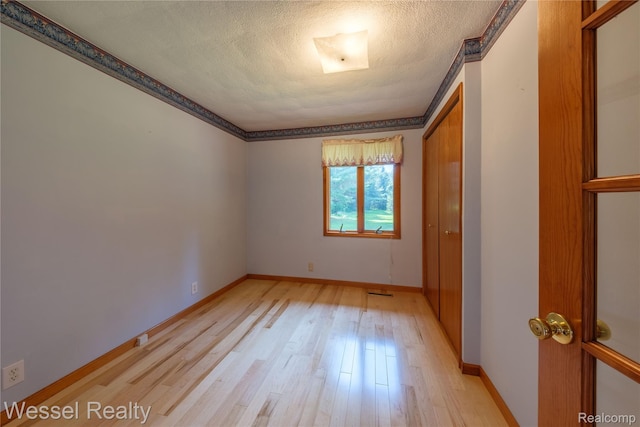2465 Texter Rd, Leonard, MI 48367 - unfurnished room with light wood-style flooring and a textured ceiling