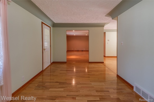 2465 Texter Rd, Leonard, MI 48367 - hall featuring light wood-type flooring and a textured ceiling