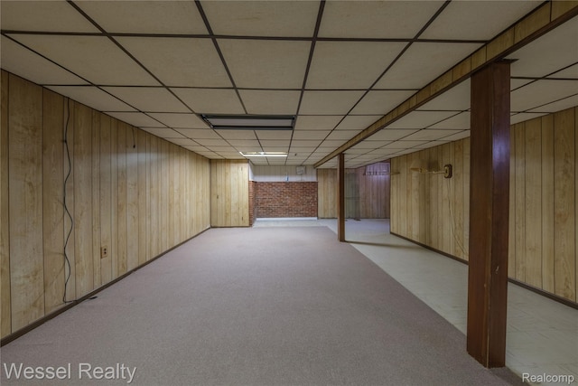2465 Texter Rd, Leonard, MI 48367 - finished basement with wooden walls, a paneled ceiling, and light colored carpet