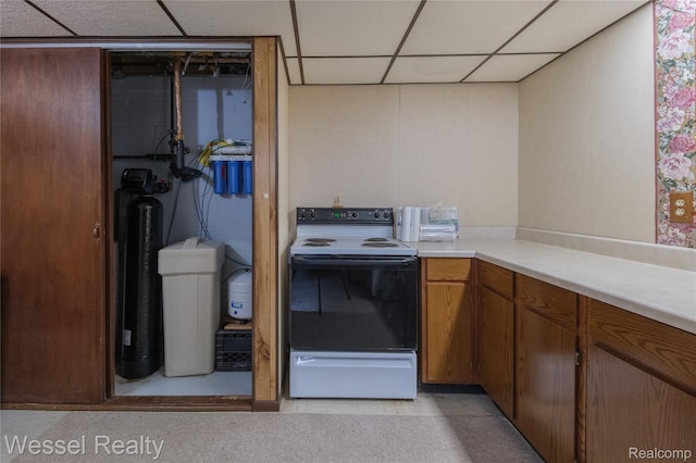 2465 Texter Rd, Leonard, MI 48367 - kitchen with range with electric stovetop, a drop ceiling, light countertops, and brown cabinetry