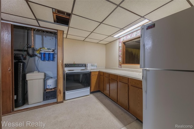 2465 Texter Rd, Leonard, MI 48367 - kitchen with white appliances, light countertops, a drop ceiling, and brown cabinets