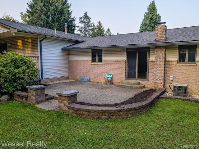 2465 Texter Rd, Leonard, MI 48367 - rear view of house with a chimney, a patio, a lawn, and entry steps