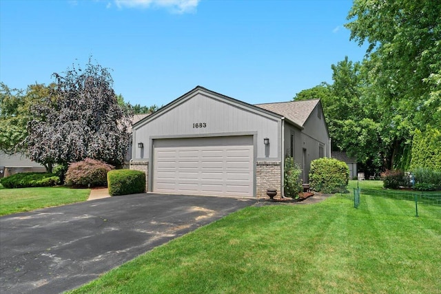 1683 Majon Dr, Highland, MI 48356 - view of front of property featuring brick siding, asphalt driveway, a garage, and a front lawn