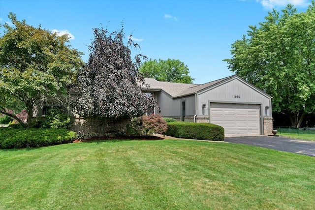 1683 Majon Dr, Highland, MI 48356 - view of front of property with driveway, a garage, a front lawn, and brick siding
