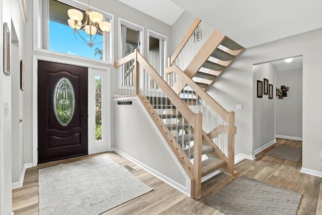 1683 Majon Dr, Highland, MI 48356 - foyer entrance featuring a chandelier, stairs, and wood finished floors
