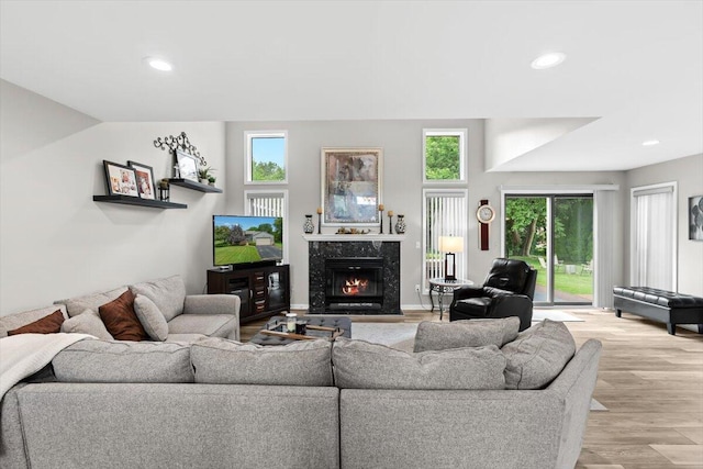 1683 Majon Dr, Highland, MI 48356 - living area with a high end fireplace, light wood finished floors, and recessed lighting