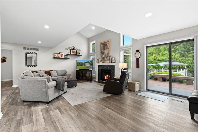 1683 Majon Dr, Highland, MI 48356 - living area featuring wood finished floors, vaulted ceiling, a fireplace, and recessed lighting