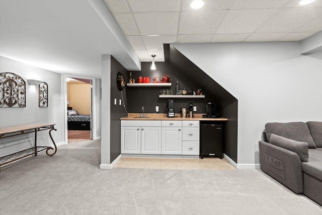 1683 Majon Dr, Highland, MI 48356 - indoor wet bar featuring light carpet, refrigerator, and a drop ceiling
