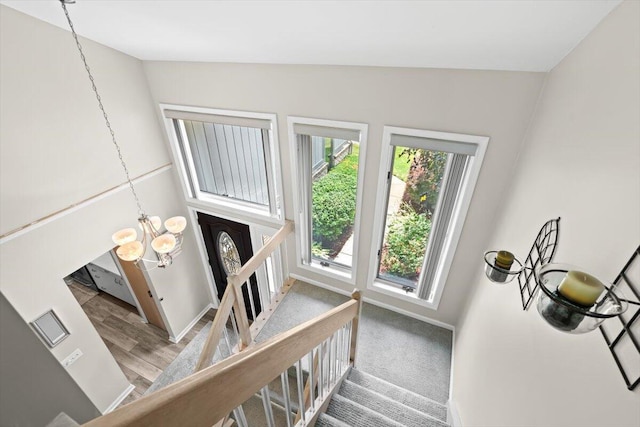 1683 Majon Dr, Highland, MI 48356 - stairs with a chandelier, wood finished floors, and lofted ceiling