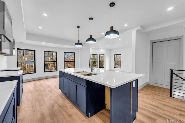 4301 Avery St, Detroit, MI 48208 - kitchen featuring light countertops, light wood finished floors, blue cabinetry, and recessed lighting