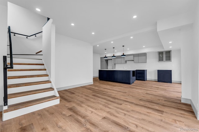 4301 Avery St, Detroit, MI 48208 - unfurnished living room with light wood-style floors, recessed lighting, and stairway