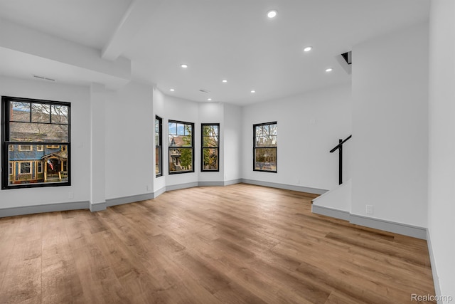 4301 Avery St, Detroit, MI 48208 - unfurnished living room featuring recessed lighting, light wood finished floors, and beamed ceiling