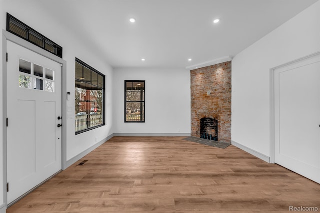 4301 Avery St, Detroit, MI 48208 - unfurnished living room with recessed lighting, a large fireplace, and light wood finished floors