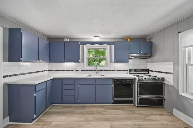1533 E Munger Rd, Tecumseh, MI 49286 - kitchen featuring black dishwasher, blue cabinetry, under cabinet range hood, gas stove, and a textured ceiling