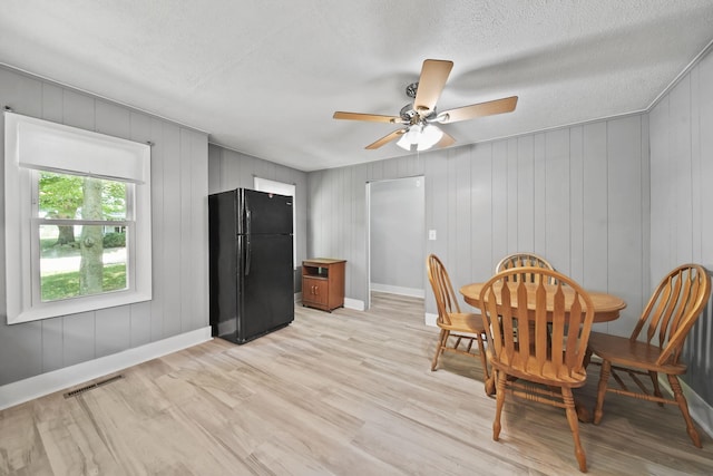 1533 E Munger Rd, Tecumseh, MI 49286 - dining room with light wood-style flooring, ceiling fan, and a textured ceiling