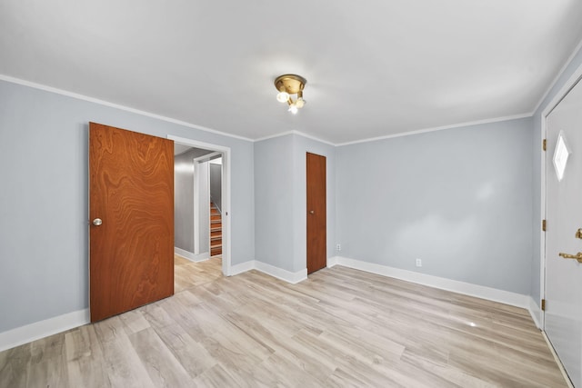 1533 E Munger Rd, Tecumseh, MI 49286 - empty room featuring light wood-type flooring, stairs, and crown molding
