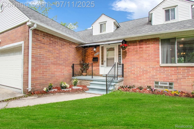 24370 Eureka Ave, Warren, MI 48091 - view of exterior entry with a yard, brick siding, and an attached garage