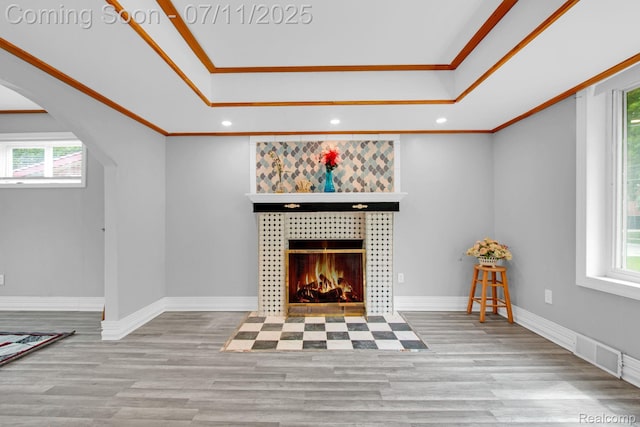 24370 Eureka Ave, Warren, MI 48091 - living room featuring a raised ceiling, arched walkways, healthy amount of natural light, ornamental molding, and recessed lighting