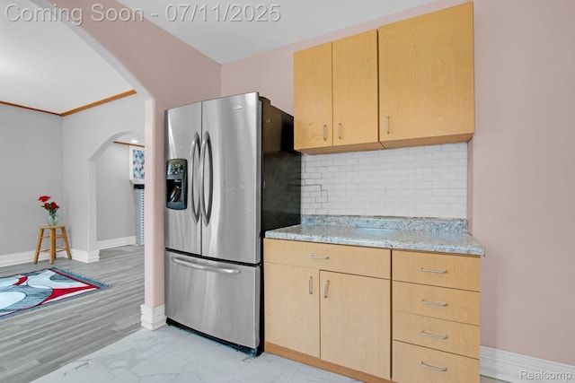 24370 Eureka Ave, Warren, MI 48091 - kitchen featuring stainless steel fridge, arched walkways, light brown cabinetry, and backsplash