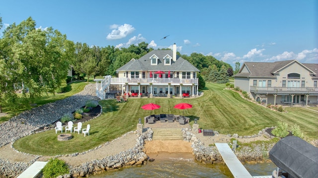 8321 Odowling Dr, Onsted, MI 49265 - back of house featuring a chimney, a lawn, a patio, a balcony, and a water view