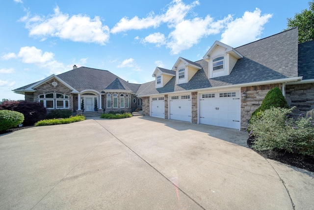 8321 Odowling Dr, Onsted, MI 49265 - french country inspired facade with stone siding, concrete driveway, a garage, and a shingled roof