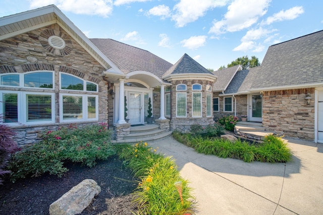 8321 Odowling Dr, Onsted, MI 49265 - view of exterior entry with stone siding and a shingled roof