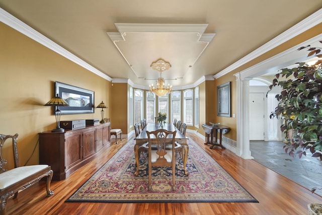 8321 Odowling Dr, Onsted, MI 49265 - dining area featuring a chandelier, ornate columns, light wood finished floors, and ornamental molding