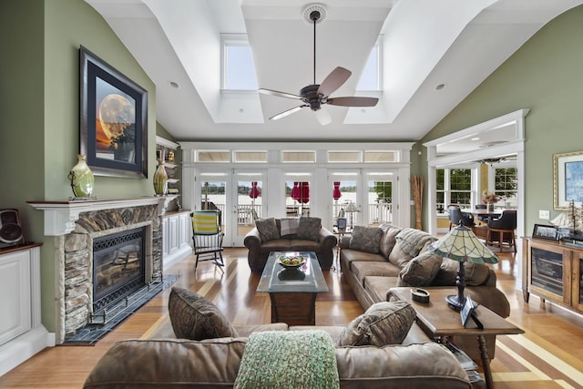 8321 Odowling Dr, Onsted, MI 49265 - living room with a skylight, ceiling fan, high vaulted ceiling, a fireplace, and light wood finished floors