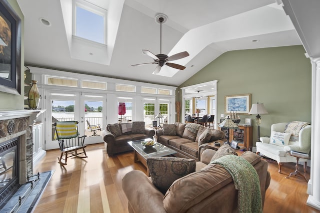 8321 Odowling Dr, Onsted, MI 49265 - living area with ceiling fan, a fireplace, wood finished floors, french doors, and high vaulted ceiling