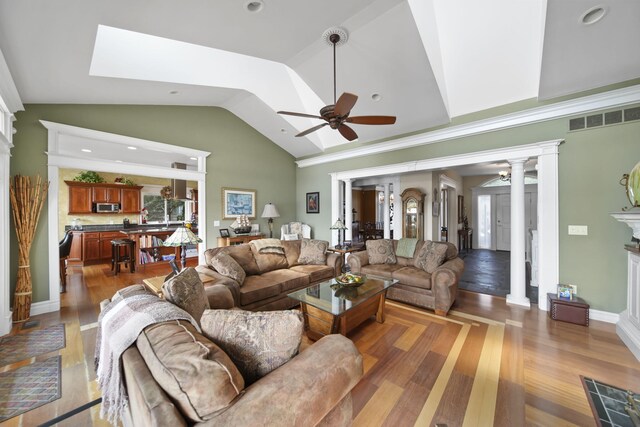 8321 Odowling Dr, Onsted, MI 49265 - living room with a ceiling fan, vaulted ceiling, ornate columns, and wood finished floors