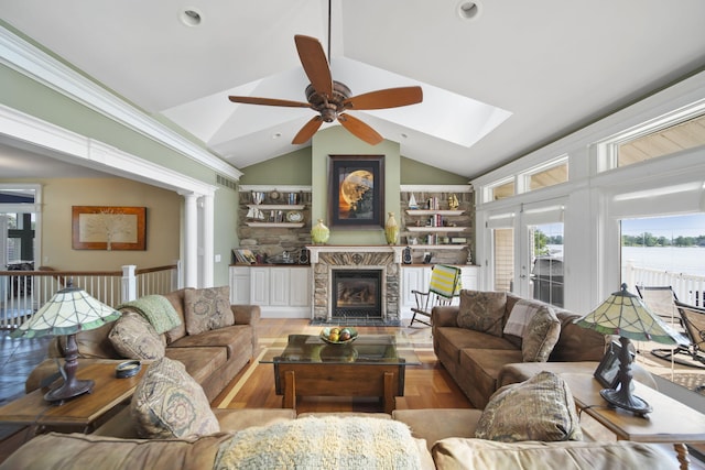 8321 Odowling Dr, Onsted, MI 49265 - living room with ceiling fan, a fireplace with flush hearth, a skylight, lofted ceiling, and recessed lighting