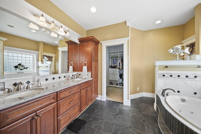 8321 Odowling Dr, Onsted, MI 49265 - bathroom with double vanity, a whirlpool tub, a spacious closet, and recessed lighting