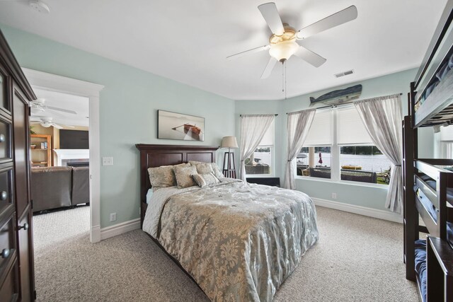8321 Odowling Dr, Onsted, MI 49265 - bedroom featuring light colored carpet, ceiling fan, and a fireplace