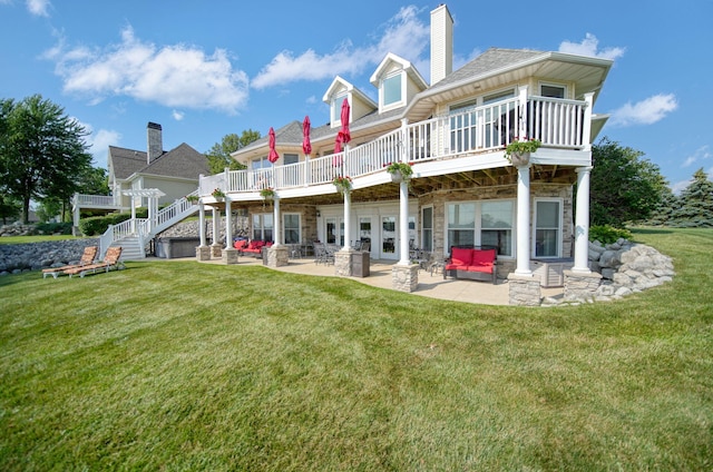8321 Odowling Dr, Onsted, MI 49265 - back of property with an outdoor hangout area, a patio, a lawn, a wooden deck, and stone siding