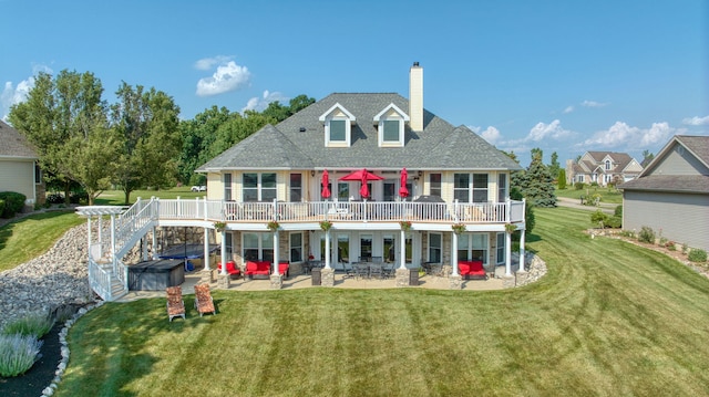 8321 Odowling Dr, Onsted, MI 49265 - rear view of house with a patio, a hot tub, a chimney, a lawn, and outdoor lounge area