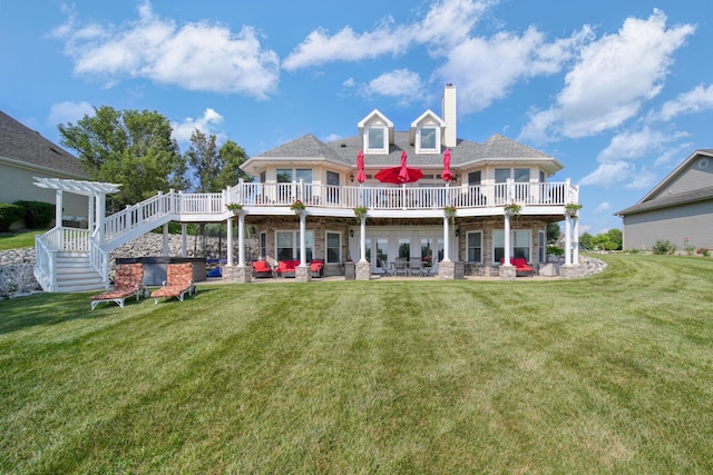 8321 Odowling Dr, Onsted, MI 49265 - back of house featuring a chimney, a wooden deck, a lawn, and stone siding