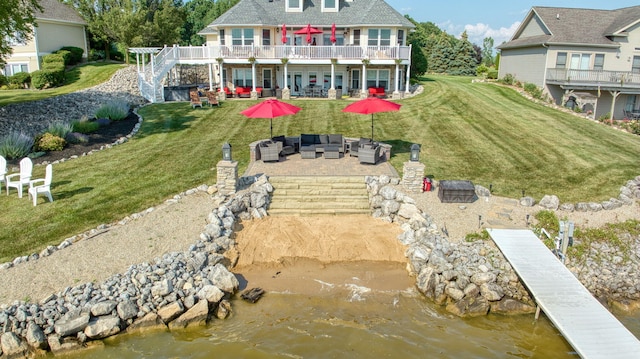 8321 Odowling Dr, Onsted, MI 49265 - back of property featuring outdoor lounge area, a patio area, stairway, a lawn, and a deck with water view