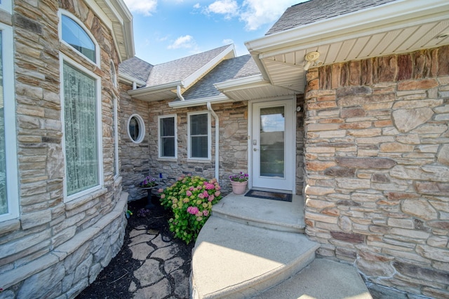 8321 Odowling Dr, Onsted, MI 49265 - view of exterior entry featuring stone siding and roof with shingles