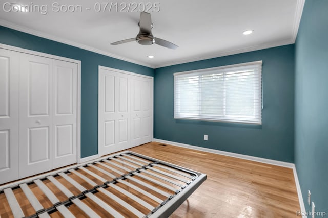 100 Billingsgate Ct, Bloomfield Hills, MI 48301 - unfurnished bedroom featuring multiple closets, wood finished floors, ornamental molding, recessed lighting, and ceiling fan