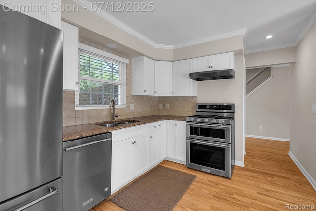 100 Billingsgate Ct, Bloomfield Hills, MI 48301 - kitchen with appliances with stainless steel finishes, under cabinet range hood, crown molding, dark stone counters, and white cabinets