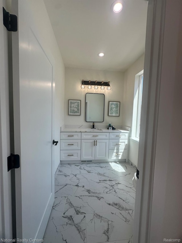 1666 Albany St, Ferndale, MI 48220 - bathroom featuring recessed lighting, marble look tile flooring, and vanity