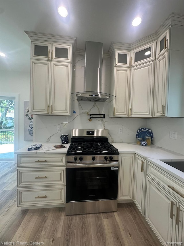1666 Albany St, Ferndale, MI 48220 - kitchen featuring stainless steel gas range, wall chimney range hood, light countertops, tasteful backsplash, and recessed lighting