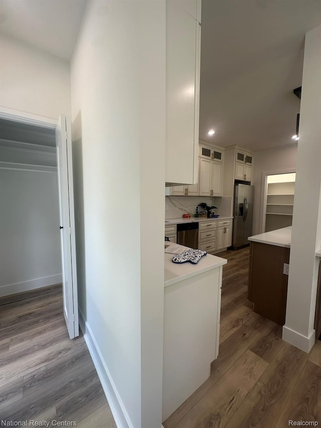 1666 Albany St, Ferndale, MI 48220 - kitchen featuring stainless steel appliances, light countertops, wood finished floors, glass insert cabinets, and recessed lighting
