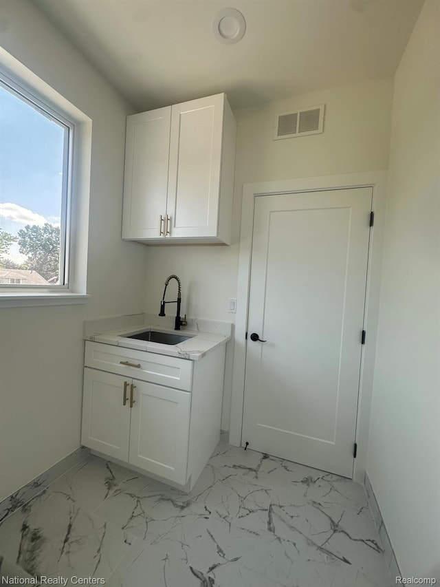 1666 Albany St, Ferndale, MI 48220 - laundry area featuring a sink and light marble finish flooring