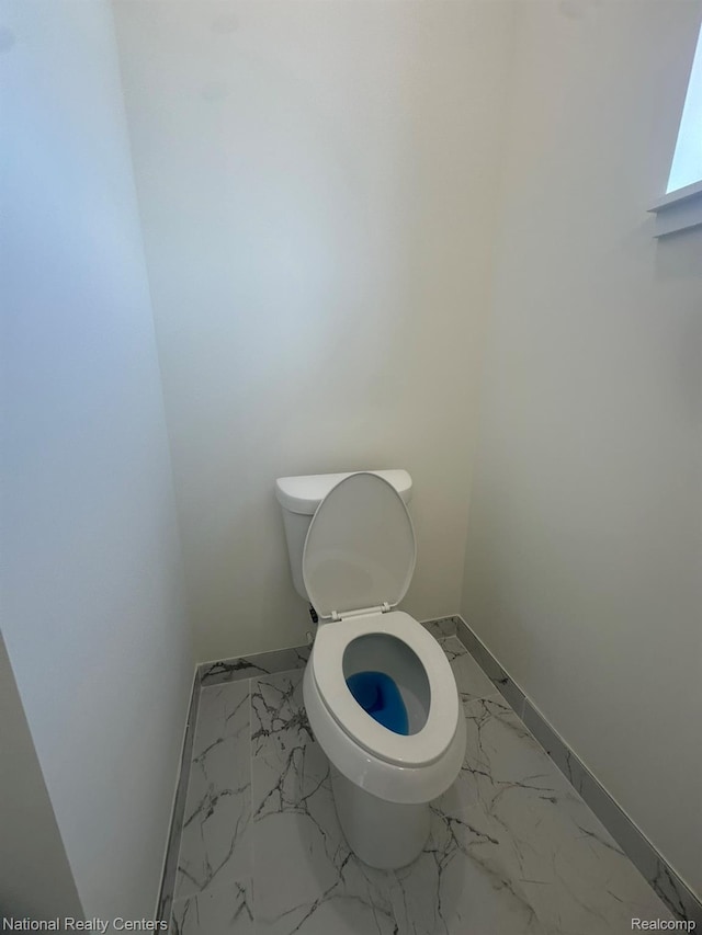 1666 Albany St, Ferndale, MI 48220 - bathroom featuring marble look tile flooring and toilet