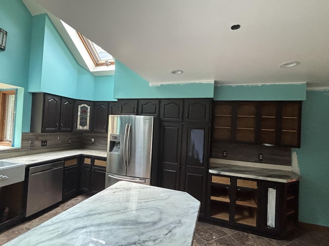 135 S Steer St, Addison, MI 49220 - kitchen with appliances with stainless steel finishes, a skylight, backsplash, lofted ceiling, and recessed lighting