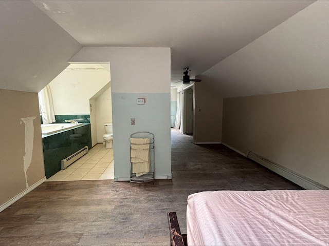 135 S Steer St, Addison, MI 49220 - bedroom with a baseboard radiator, lofted ceiling, wood finished floors, ensuite bathroom, and a ceiling fan